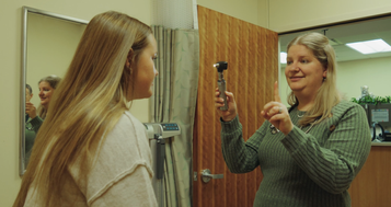 Dr. Shannon VanderKooi assists a female patient with an exam